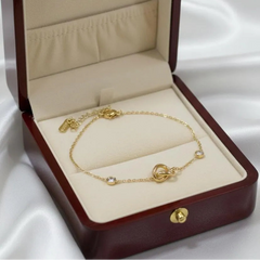 Gold Plated Chain Bracelet Featuring A Knot Motif